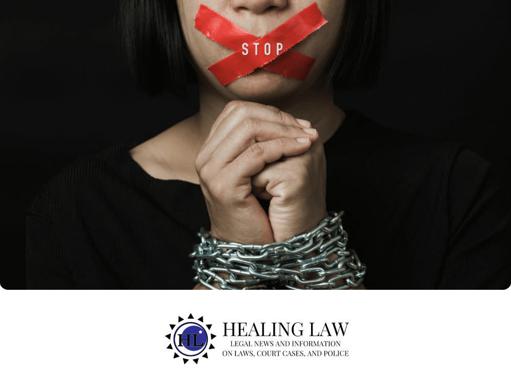 Stock image of a person who is chained by the hands and has their mouth covered with red tape. The word "stop" is displayed across the red tape.