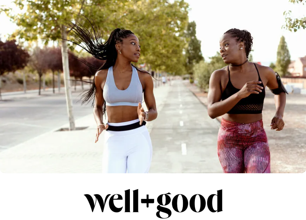 Stock image of two women on a jog looking at each other.