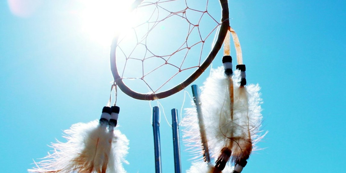 Dream catcher hanging in the sun and blue sky.