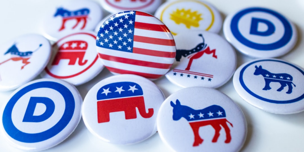 A bunch of buttons with political party symbols on them.