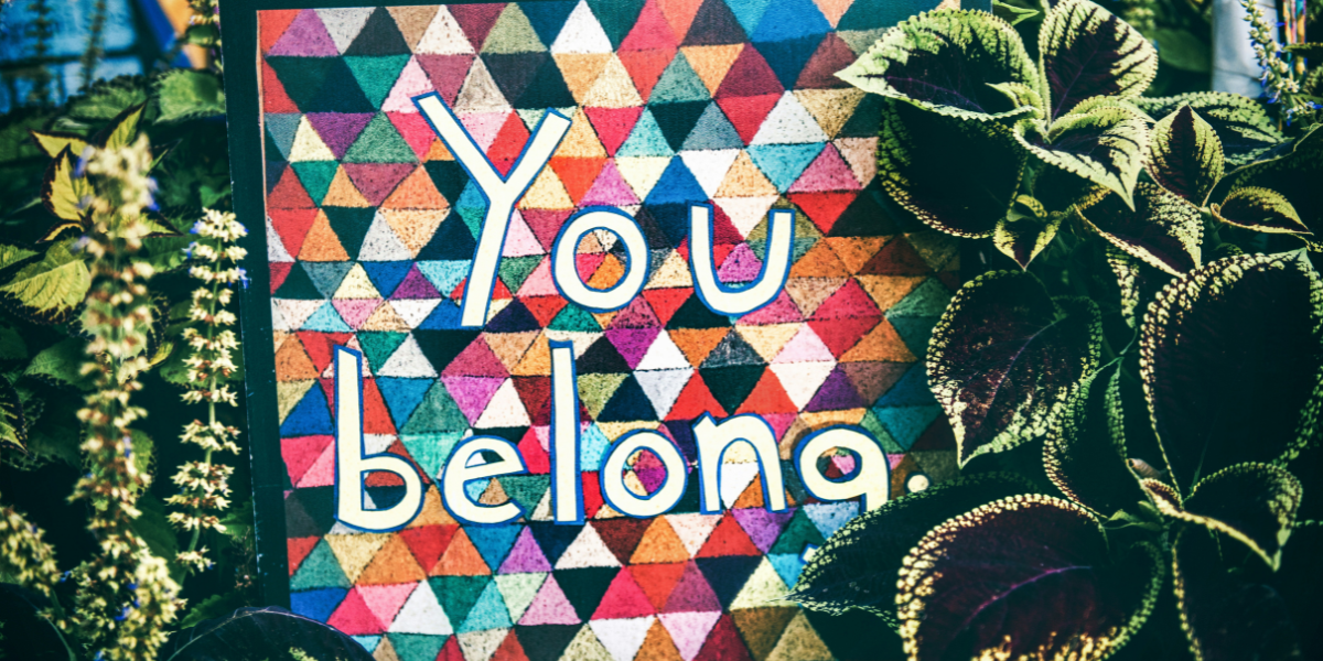 A colorful sign that says "you belong."