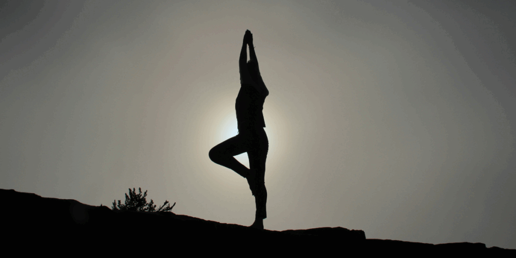 A person doing yoga outside.