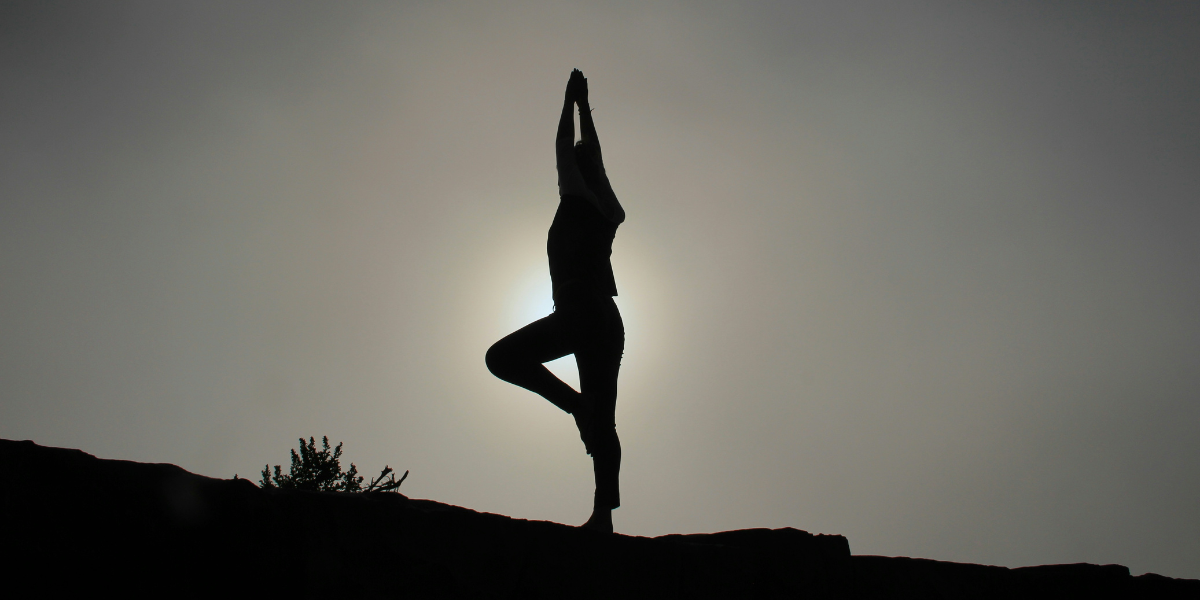 A person doing yoga outside.