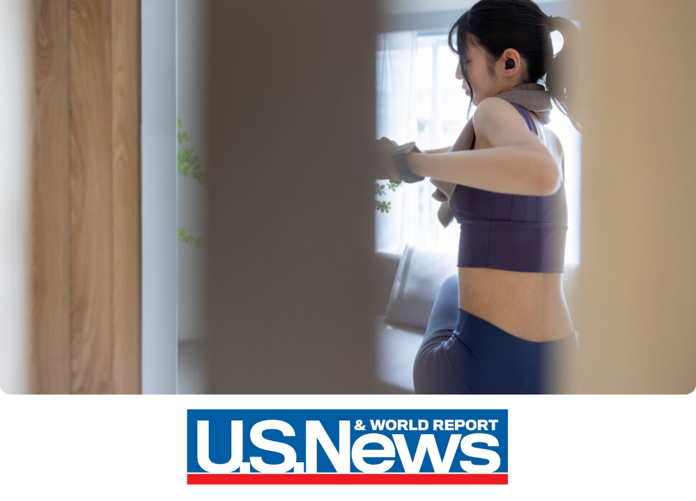 Stock Image of a woman exercising in her home.