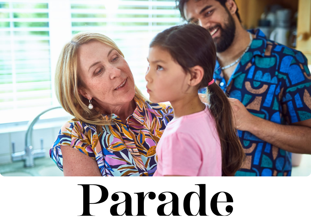 Stock Image of parents holding their child in a kitchen.