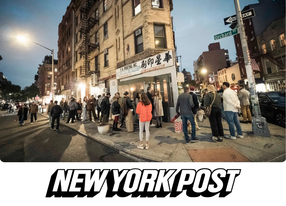 Stock Image of many people waiting in line outside a restaurant.