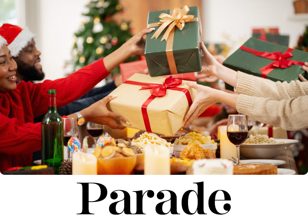 Stock image of people at a table exchanging presents.