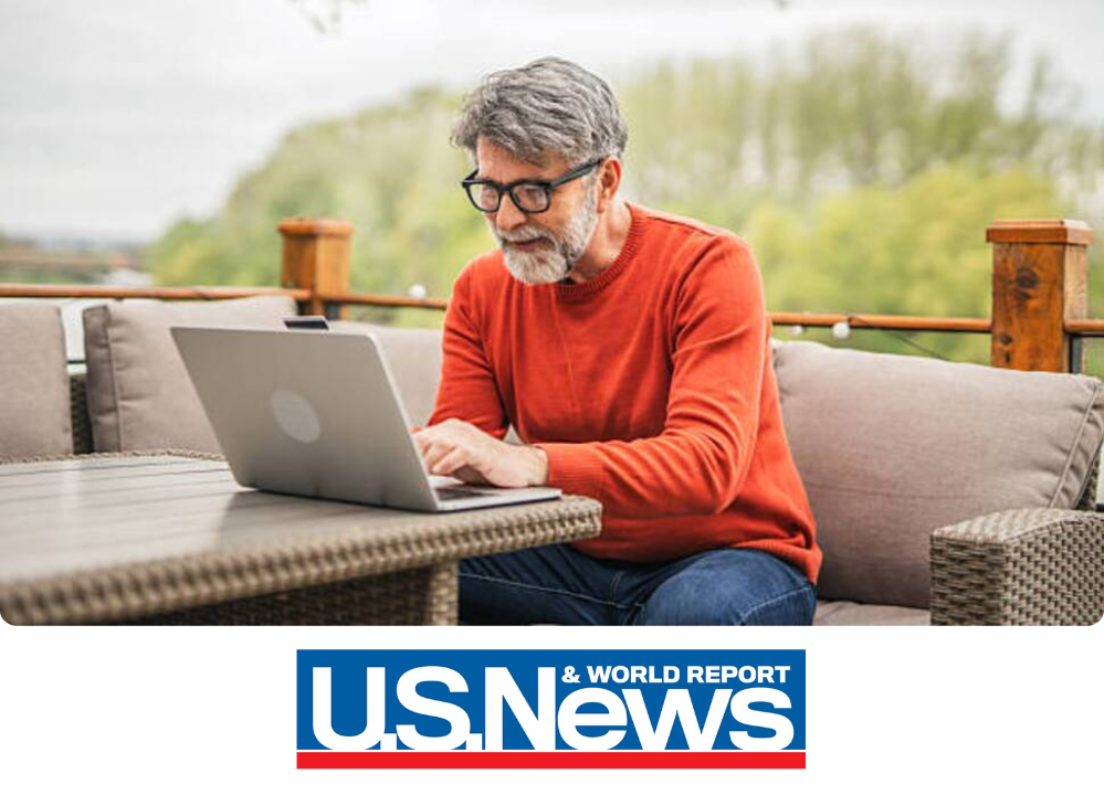 Stock Image of a man outside on his laptop.